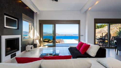  Elounda Black Pearl - Spacious living room area with access to the pool  