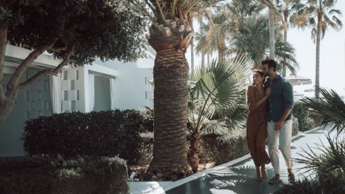  Mykonos Blanc Hotel - Walking next to palm trees 